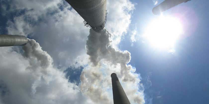 Smoke stacks against a blue sky